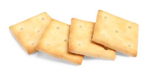 Photo of Tasty crispy square crackers isolated on white