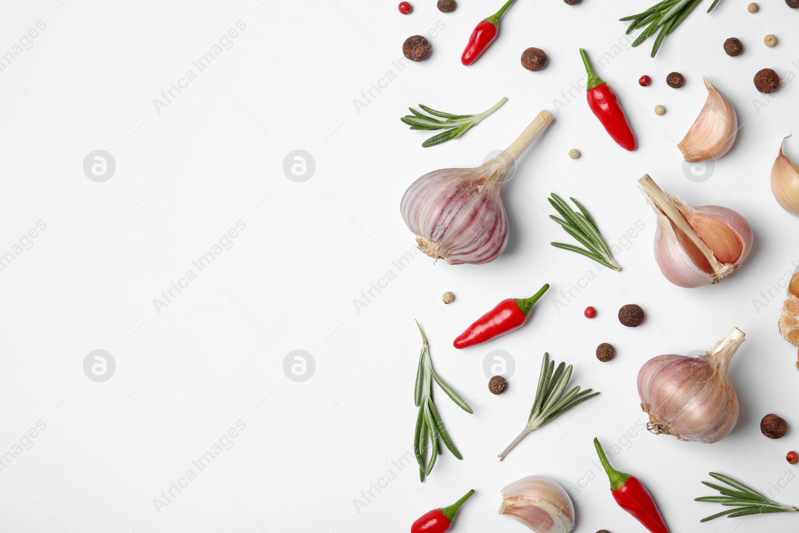 Photo of Composition with garlic, rosemary and peppers on white background, top view. Space for text