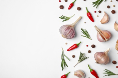 Photo of Composition with garlic, rosemary and peppers on white background, top view. Space for text