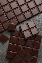 Photo of Delicious dark chocolate on grey table, flat lay