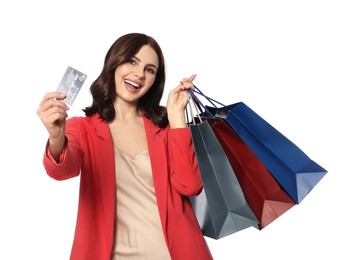 Beautiful young woman with paper shopping bags and credit card on white background