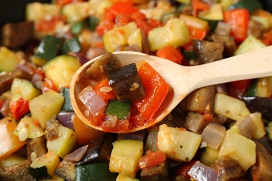 Delicious ratatouille and wooden spoon as background, closeup