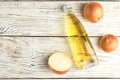 Photo of Flat lay composition with onion syrup in bottle and space for text on table