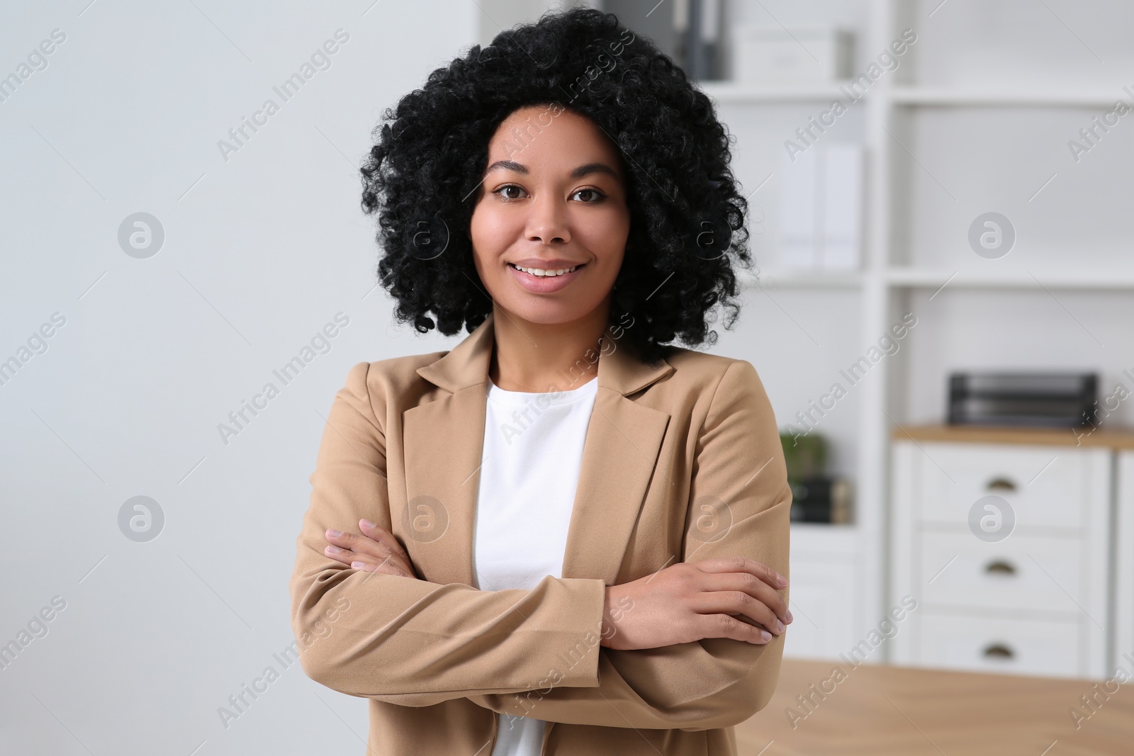 Photo of Smiling young businesswoman in her modern office