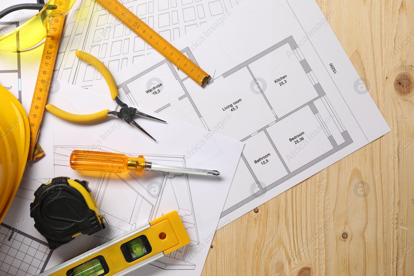 Photo of Flat lay composition with building level and other different construction tools on wooden background