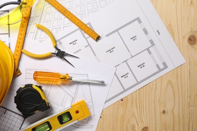 Flat lay composition with building level and other different construction tools on wooden background