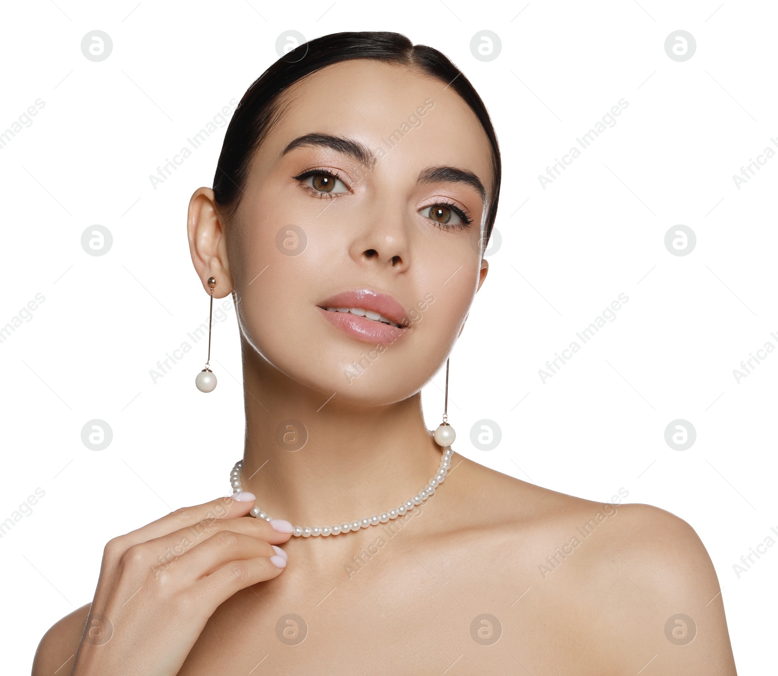 Photo of Young woman wearing elegant pearl jewelry on white background