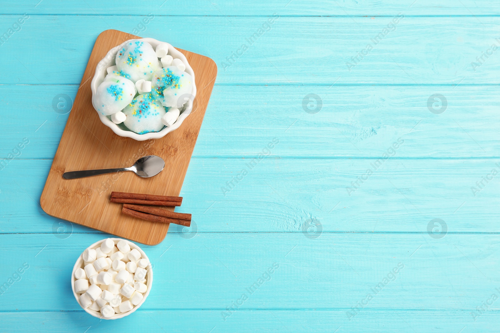 Photo of Flat lay composition with snow ice cream in bowl, marshmallows and space for text on color background