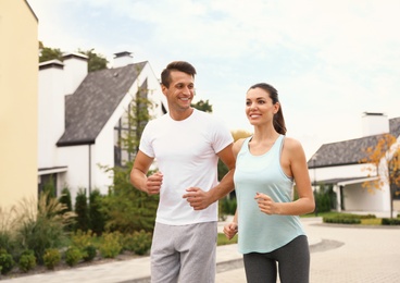 Sporty couple running on street. Healthy lifestyle