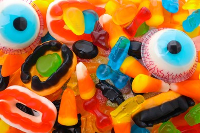 Photo of Delicious colorful candies as background, top view. Halloween sweets