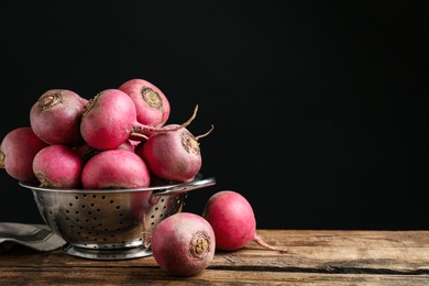 Red turnips on wooden table. Space for text