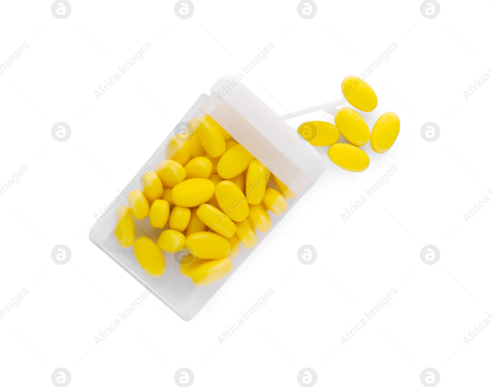 Photo of Tasty yellow dragee candies in box on white background, top view