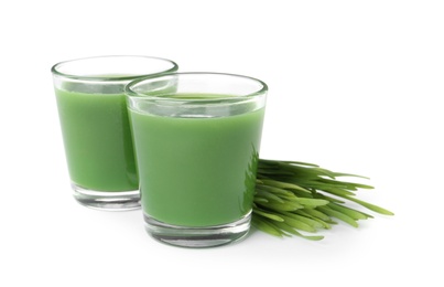 Photo of Glasses of fresh wheat grass juice and sprouts on white background