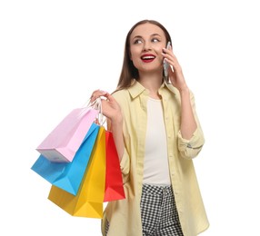 Photo of Stylish young woman with shopping bags talking on smartphone against white background