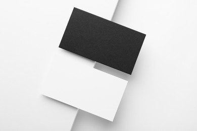 Photo of Blank business cards on white background, flat lay. Mockup for design