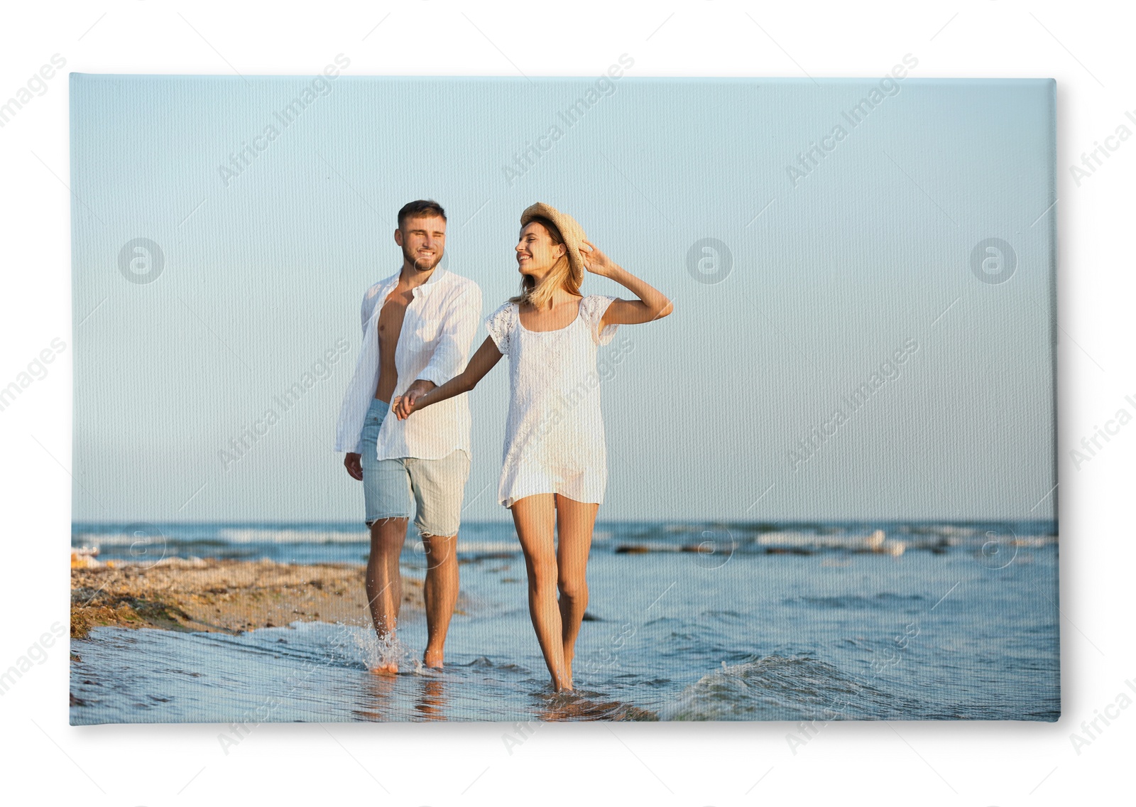 Image of Photo printed on canvas, white background. Happy young couple on beach