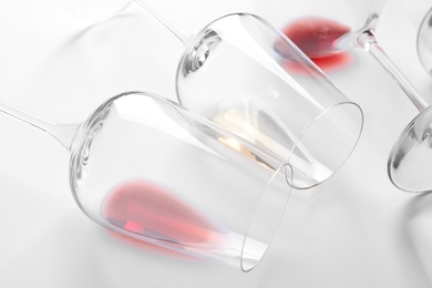 Photo of Glasses with different wine on white background, closeup