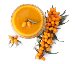 Delicious sea buckthorn jam in jar and fresh berries on white background, top view