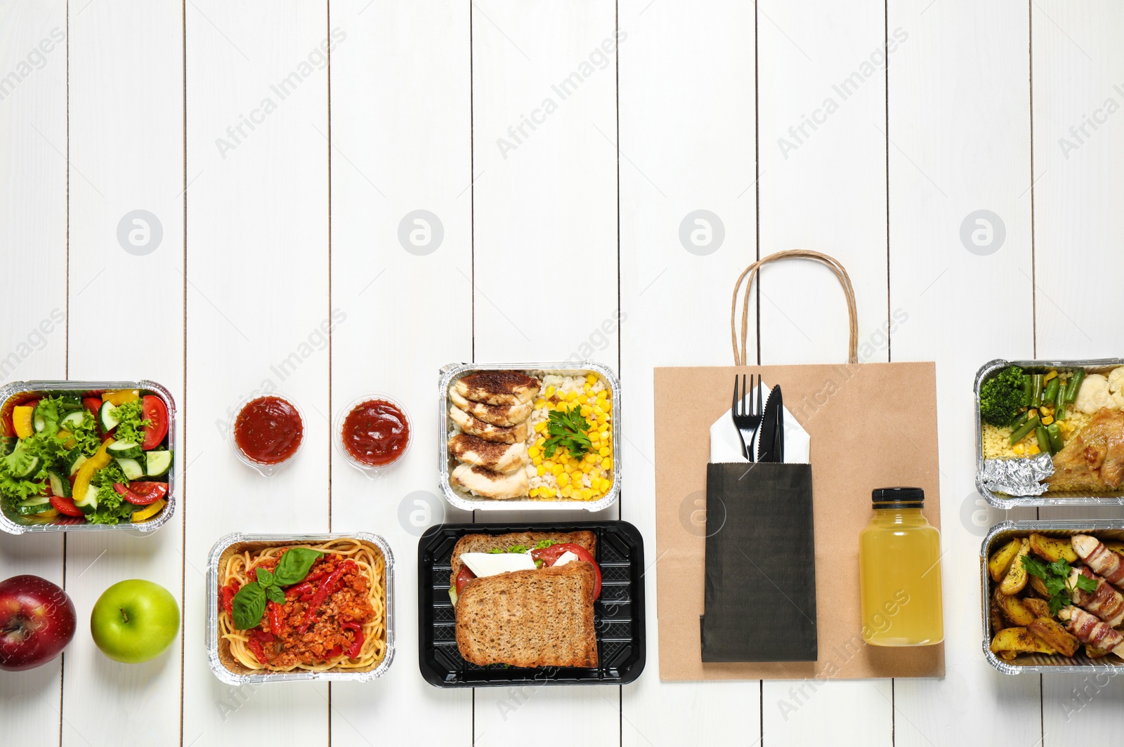 Photo of Lunchboxes on white wooden table, flat lay. Healthy food delivery