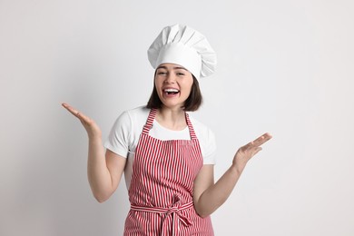 Photo of Portrait of happy confectioner on light grey background