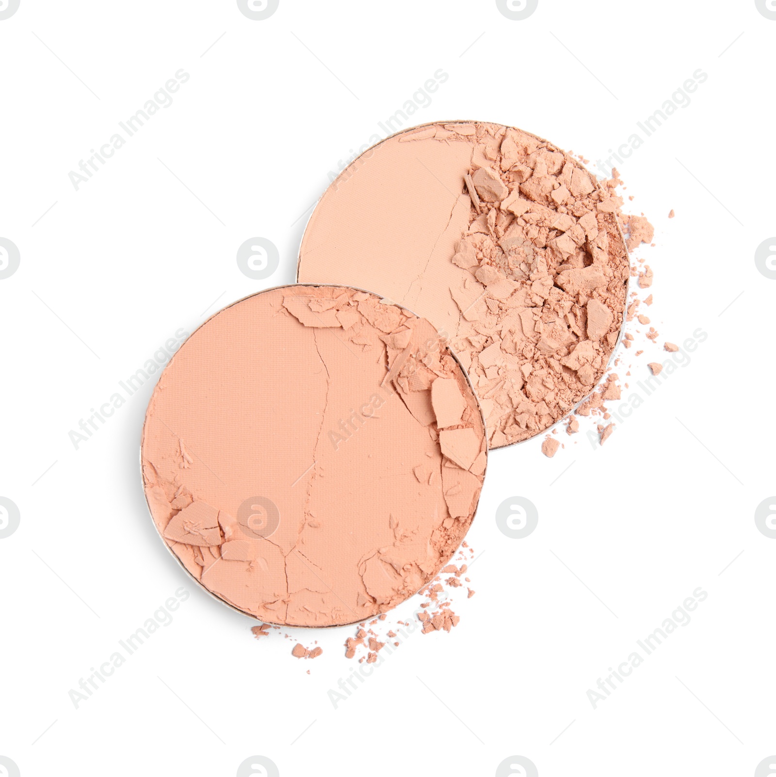 Photo of Different broken face powders on white background, top view