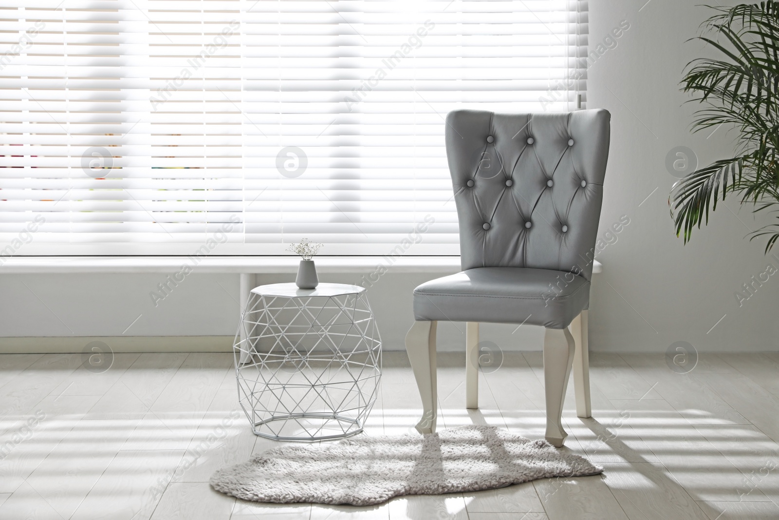 Photo of Stylish silver chairs and table near window in room