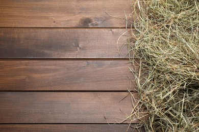 Photo of Dried hay on wooden table, top view. Space for text