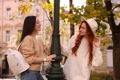 Photo of Happy friends having fun outdoors on autumn day