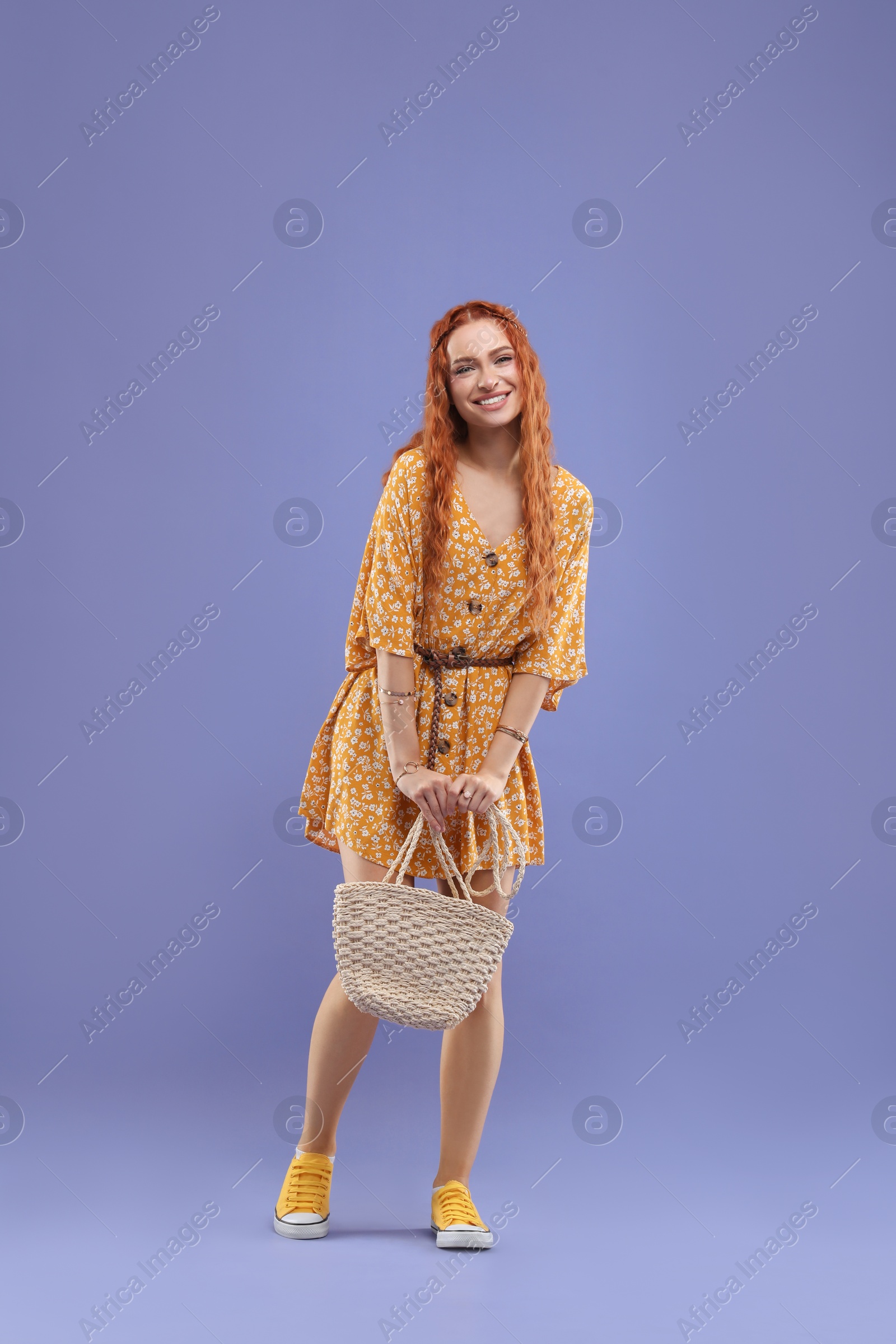 Photo of Stylish young hippie woman on violet background