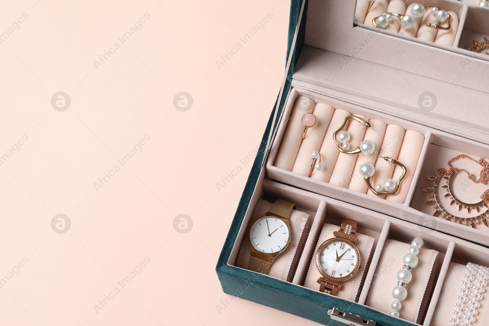 Photo of Jewelry box with many different accessories on beige background, above view. Space for text