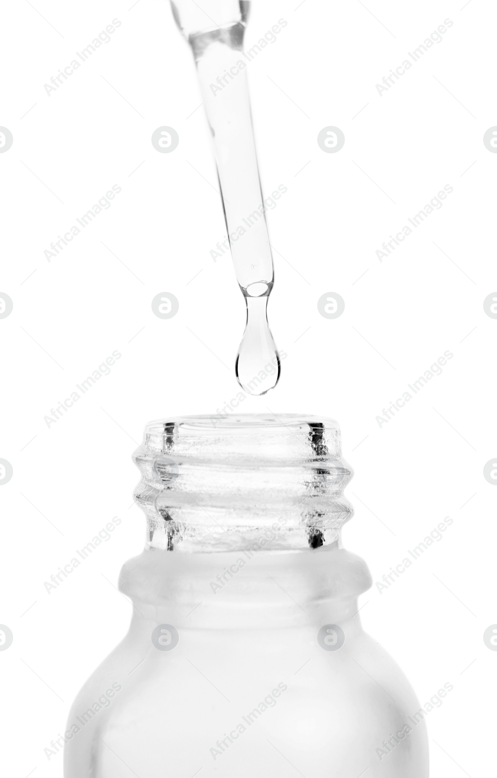 Photo of Dripping liquid from pipette into bottle isolated on white, closeup