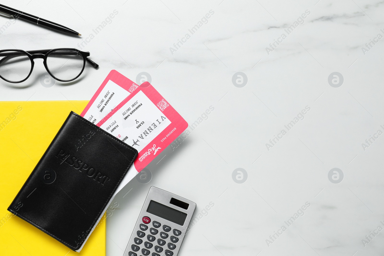 Photo of Flat lay composition with tickets, passport and calculator on white marble table, space for text. Business trip