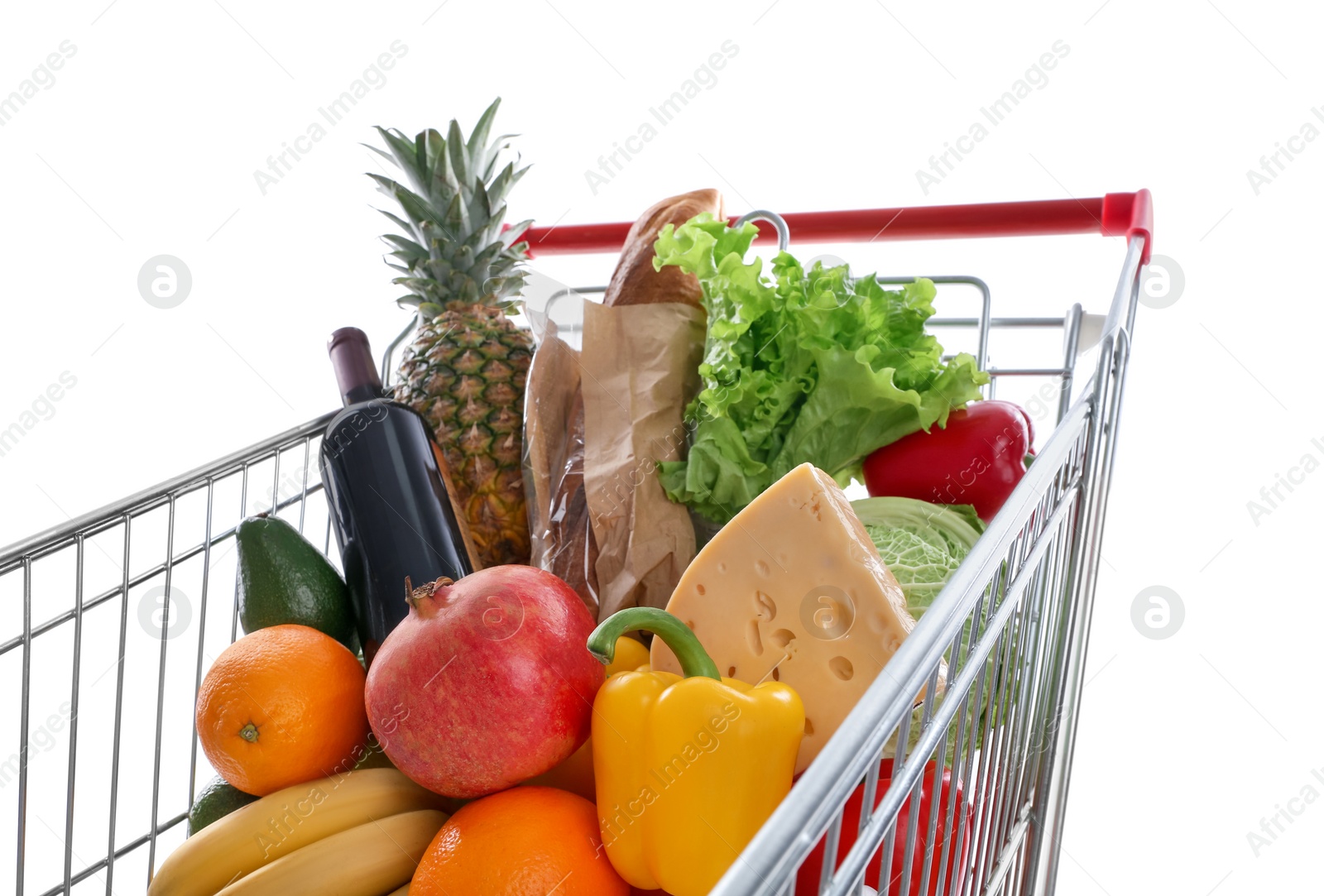 Photo of Shopping cart with groceries on white background, closeup