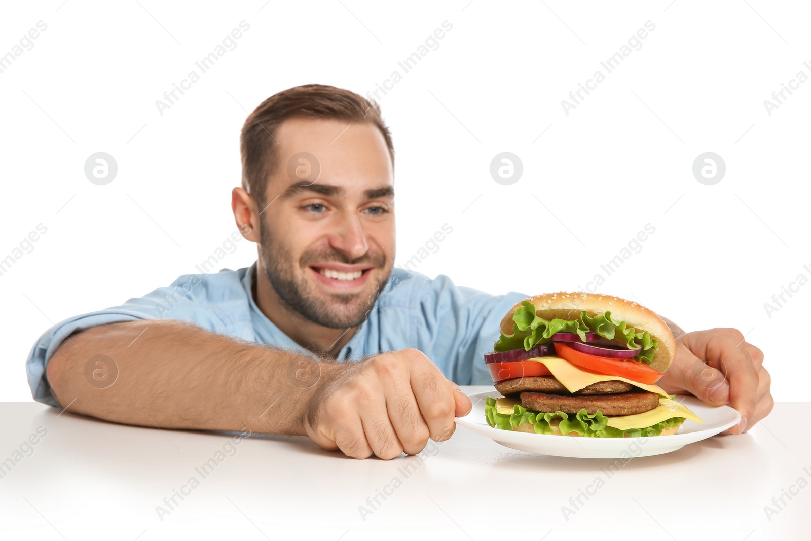 Photo of Young man with tasty burger on white background