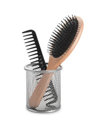 Photo of New hair brush and comb in metal holder isolated on white