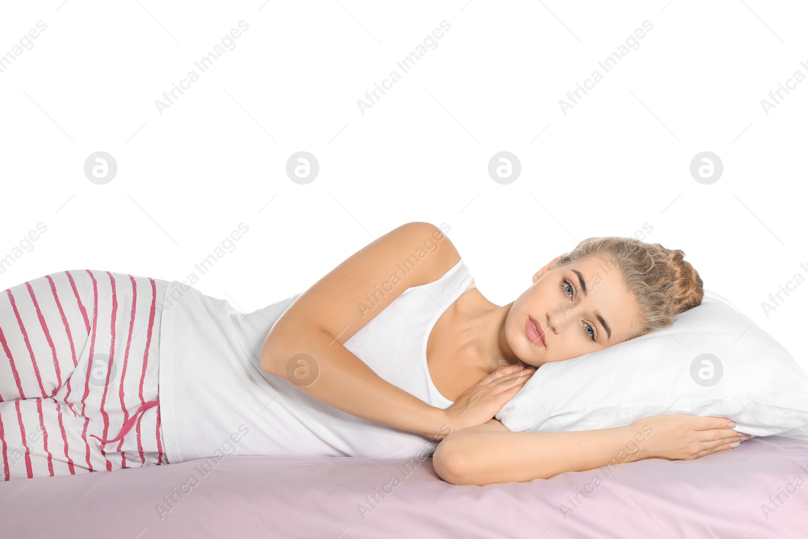 Photo of Beautiful woman lying with comfortable pillow on bed against white background