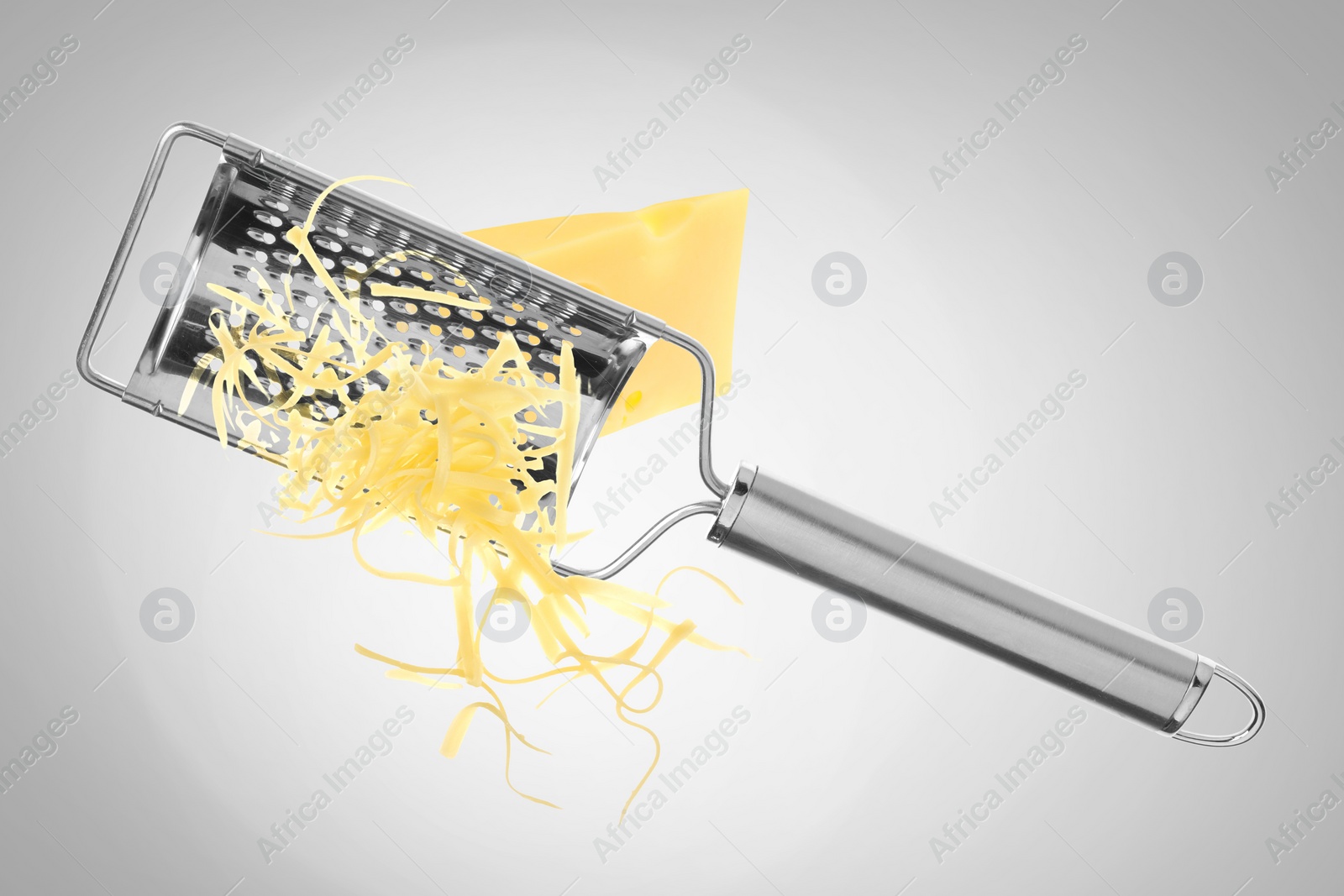 Image of Grating cheese with hand grater on grey background