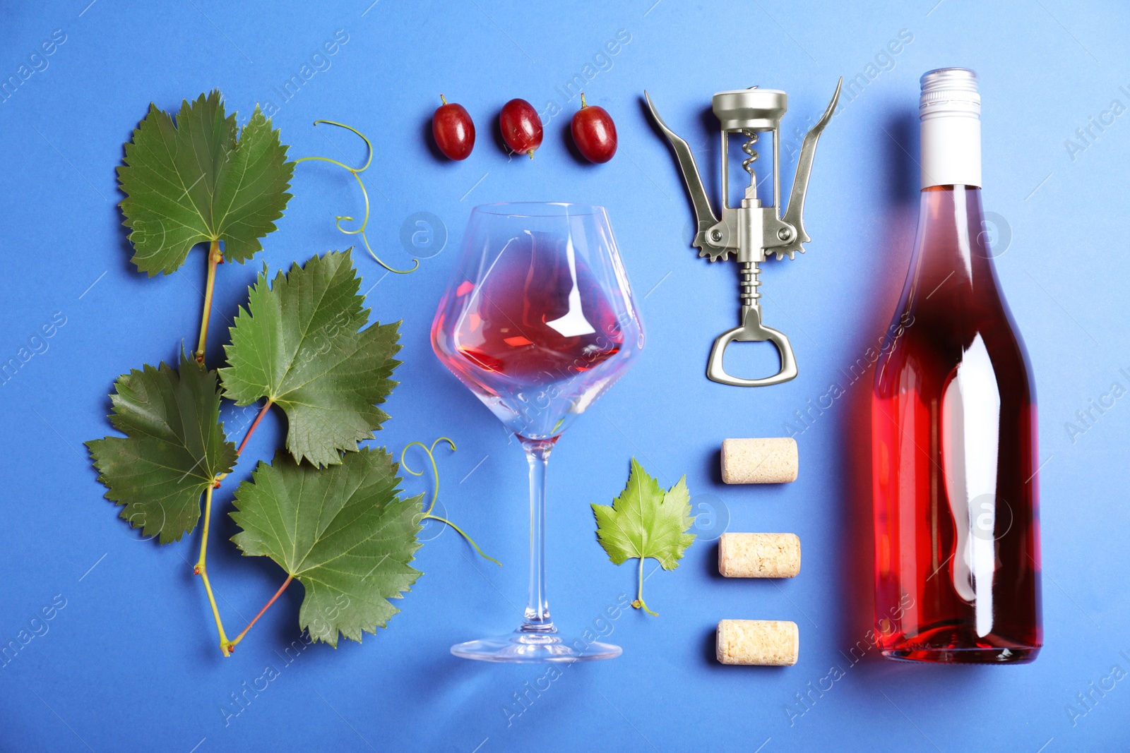 Photo of Flat lay composition with fresh ripe juicy grapes on blue background