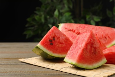 Photo of Slices of tasty ripe watermelon on wooden table