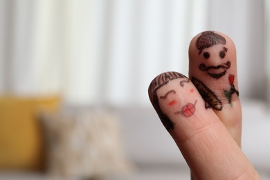 Photo of Two fingers with drawings of happy faces on blurred background, space for text. Spending time together