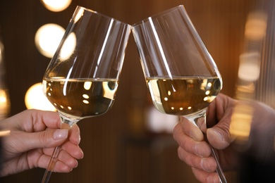 People with glasses of wine on blurred background, closeup