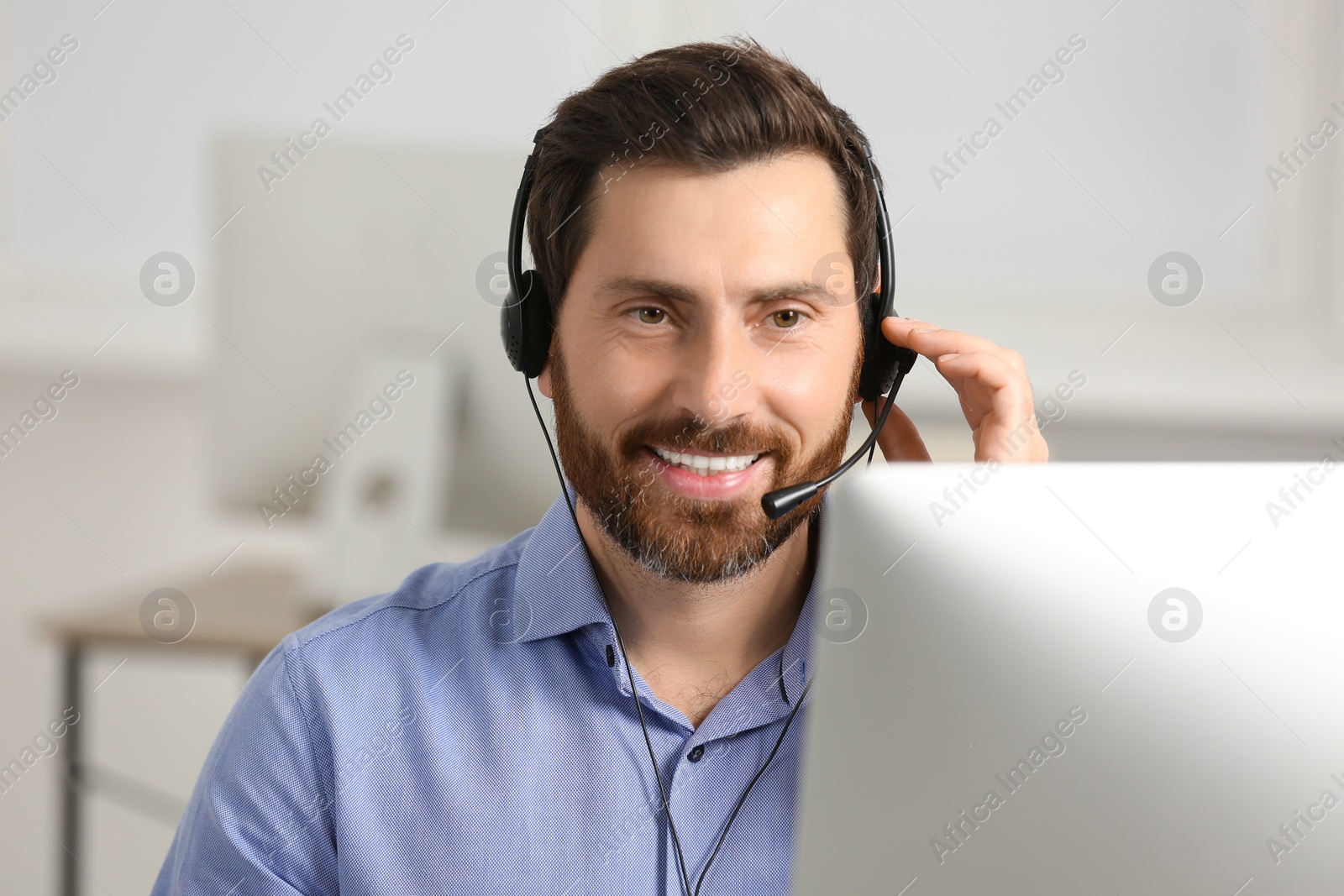 Photo of Hotline operator with headset working in office, space for text