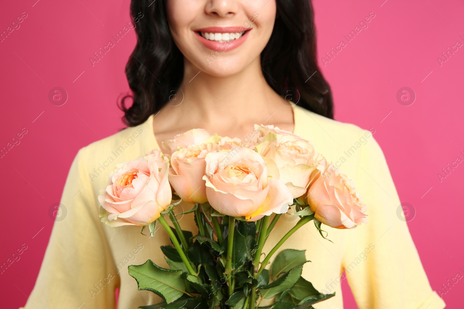 Photo of Young woman with beautiful bouquet on pink background, closeup