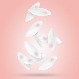 Image of White lotus flower petals falling on pink background