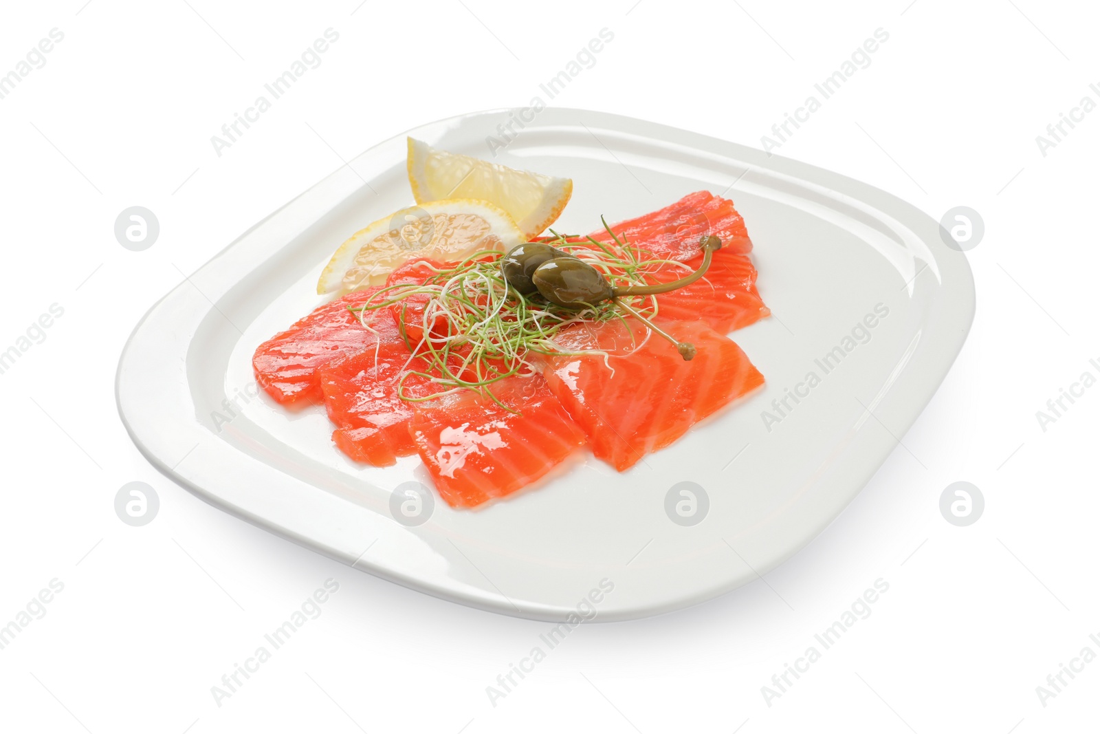 Photo of Salmon carpaccio with capers, microgreens and lemon isolated on white