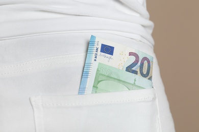 Photo of Person with Euro banknotes in pocket of jeans, closeup