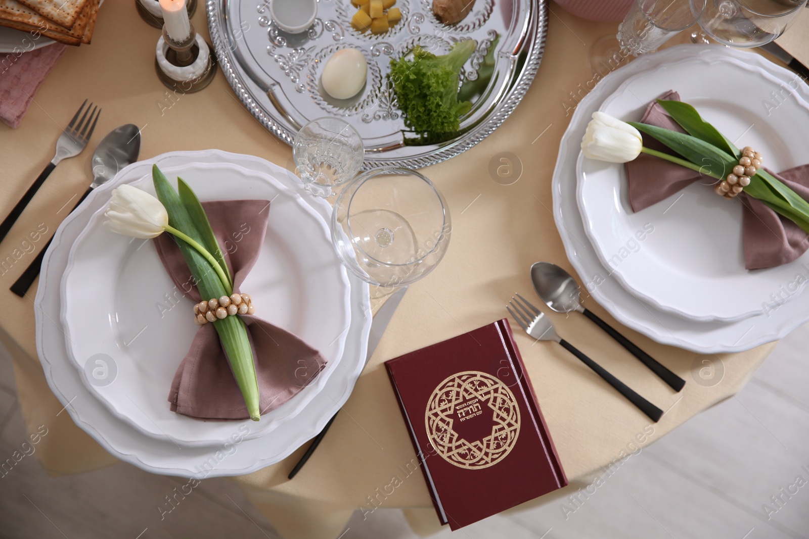 Photo of Festive Passover table setting with Torah, top view. Pesach celebration