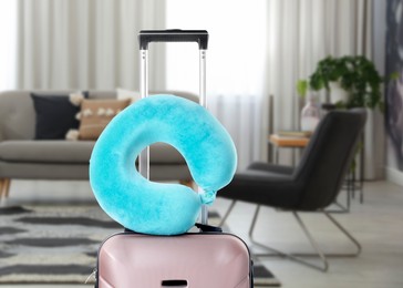 Image of Soft travel pillow on suitcase in room