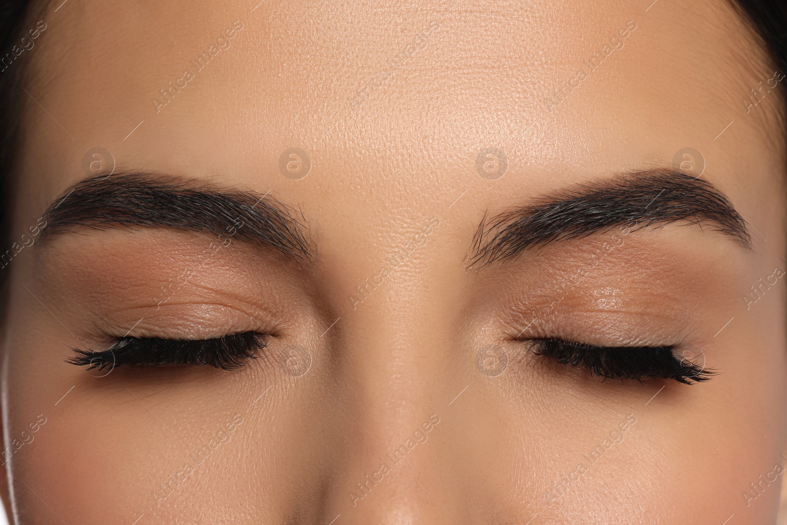 Photo of Beautiful young woman with long eyelashes, closeup