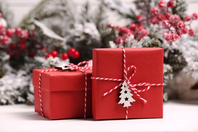 Photo of Beautiful gift boxes and Christmas decor on white table